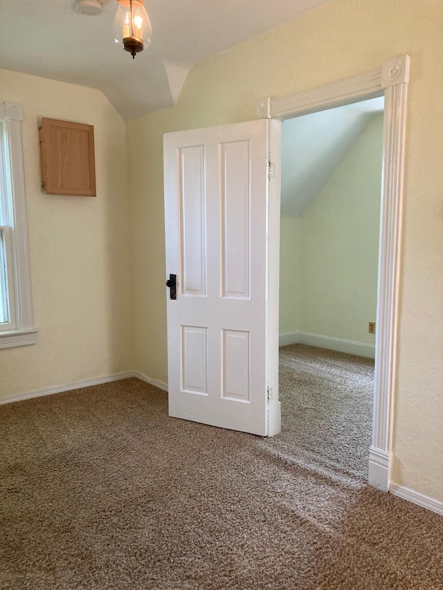 643 Miller Ave, Windom, MN 56101 - carpeted empty room featuring vaulted ceiling and baseboards