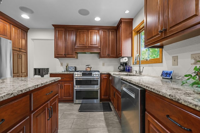 11960 Albavar Path, Inver Grove Heights, MN 55077 - kitchen featuring appliances with stainless steel finishes, a sink, light stone countertops, range hood, and light tile patterned floors