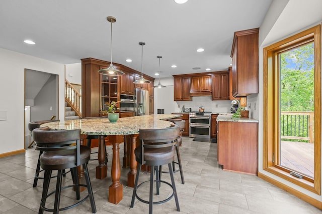11960 Albavar Path, Inver Grove Heights, MN 55077 - kitchen featuring stainless steel appliances, light stone countertops, recessed lighting, baseboards, and a kitchen bar