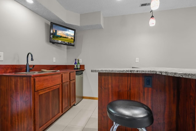 11960 Albavar Path, Inver Grove Heights, MN 55077 - indoor dry bar featuring light tile patterned floors, a textured ceiling, baseboards, stainless steel dishwasher, and pendant lighting