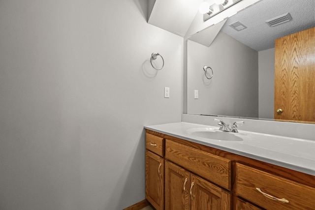 11960 Albavar Path, Inver Grove Heights, MN 55077 - bathroom with vanity, a textured ceiling, and baseboards