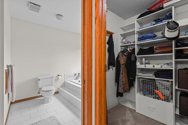 11960 Albavar Path, Inver Grove Heights, MN 55077 - bathroom with a bath, toilet, baseboards, tile patterned floors, and a textured ceiling