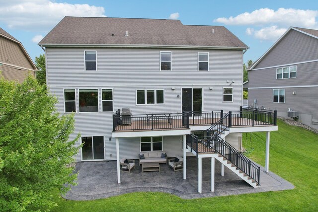 18482 Aubrie Ct, Eden Prairie, MN 55347 - back of property with stairway, an outdoor hangout area, a patio, a lawn, and a deck