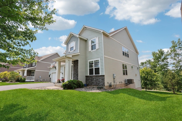 18482 Aubrie Ct, Eden Prairie, MN 55347 - view of front of home featuring stone siding, a front lawn, and driveway