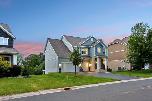 18482 Aubrie Ct, Eden Prairie, MN 55347 - view of front of home with driveway, a garage, and a front lawn