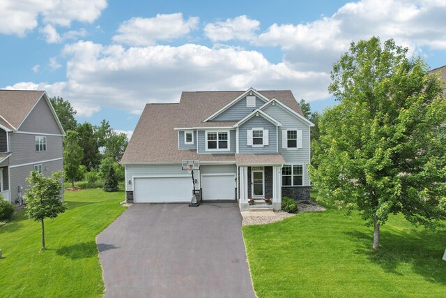 18482 Aubrie Ct, Eden Prairie, MN 55347 - view of front facade with stone siding, asphalt driveway, a front yard, and a shingled roof