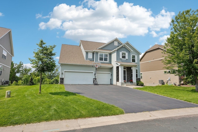 18482 Aubrie Ct, Eden Prairie, MN 55347 - view of front facade featuring asphalt driveway, stone siding, a front lawn, an attached garage, and a shingled roof