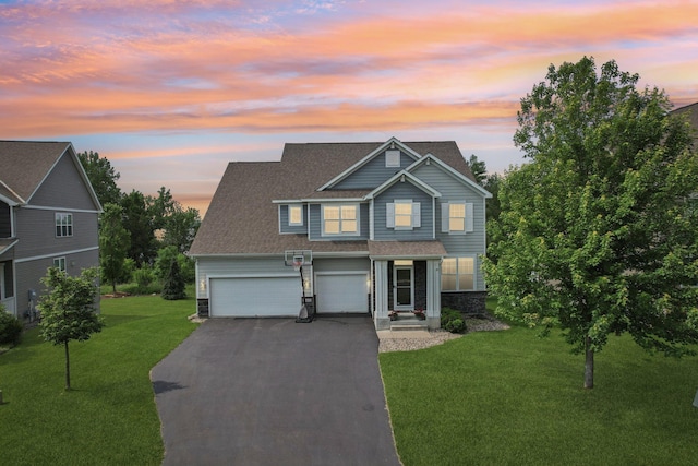 18482 Aubrie Ct, Eden Prairie, MN 55347 - traditional-style house featuring stone siding, asphalt driveway, a lawn, a shingled roof, and a garage