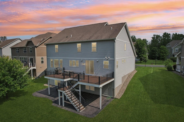 18482 Aubrie Ct, Eden Prairie, MN 55347 - back of property at dusk with a deck, a lawn, stairway, and a patio