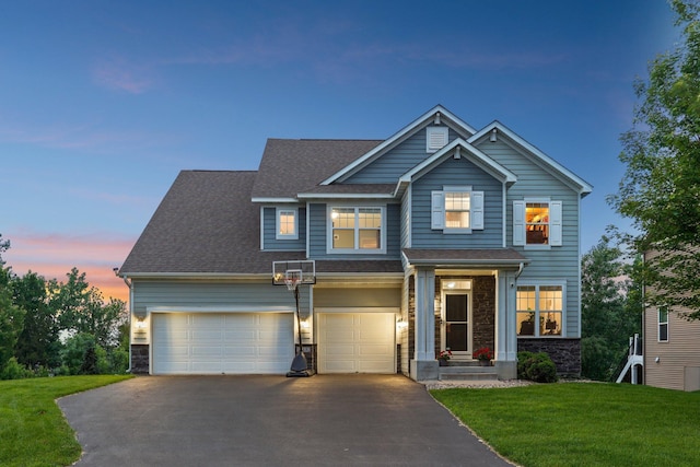 18482 Aubrie Ct, Eden Prairie, MN 55347 - view of front of house featuring driveway, stone siding, a lawn, and a shingled roof