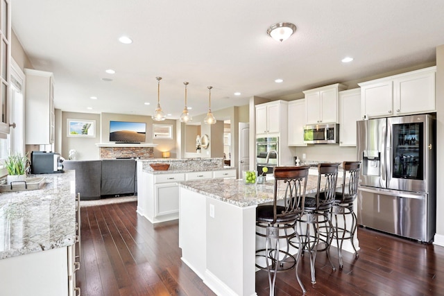 18482 Aubrie Ct, Eden Prairie, MN 55347 - kitchen featuring stainless steel appliances, dark wood-style flooring, white cabinetry, a kitchen island with sink, and recessed lighting