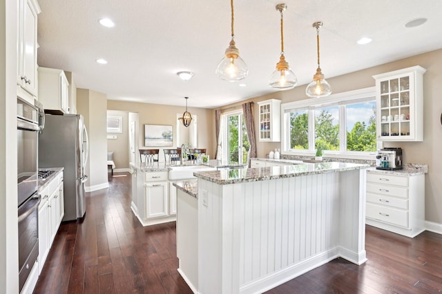 18482 Aubrie Ct, Eden Prairie, MN 55347 - kitchen featuring a kitchen island, glass insert cabinets, dark wood-type flooring, and recessed lighting