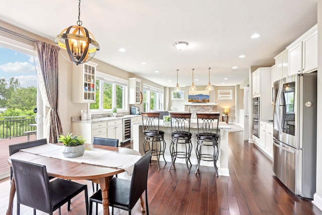 18482 Aubrie Ct, Eden Prairie, MN 55347 - dining space featuring dark wood finished floors, a chandelier, beverage cooler, and recessed lighting