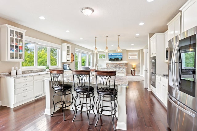 18482 Aubrie Ct, Eden Prairie, MN 55347 - kitchen with stainless steel appliances, an island with sink, glass insert cabinets, dark wood-type flooring, and recessed lighting
