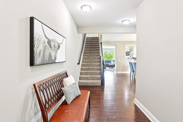 18482 Aubrie Ct, Eden Prairie, MN 55347 - hall featuring stairway, wood-type flooring, and a textured ceiling