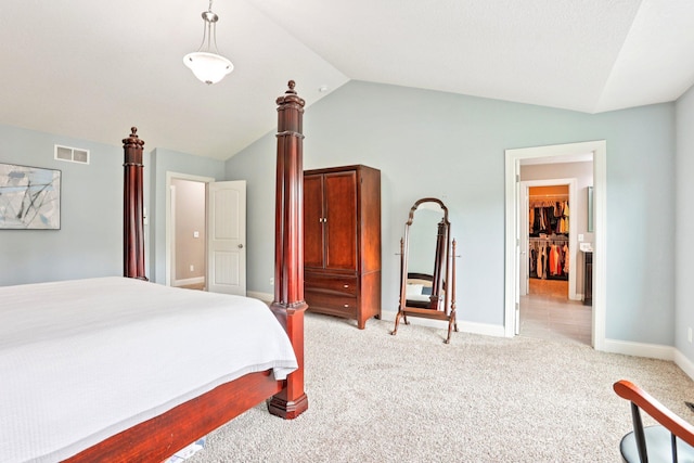 18482 Aubrie Ct, Eden Prairie, MN 55347 - bedroom with lofted ceiling, light colored carpet, and a walk in closet