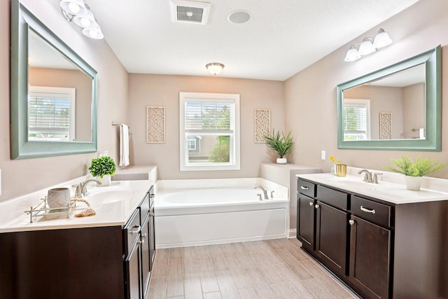 18482 Aubrie Ct, Eden Prairie, MN 55347 - bathroom with two vanities and a garden tub