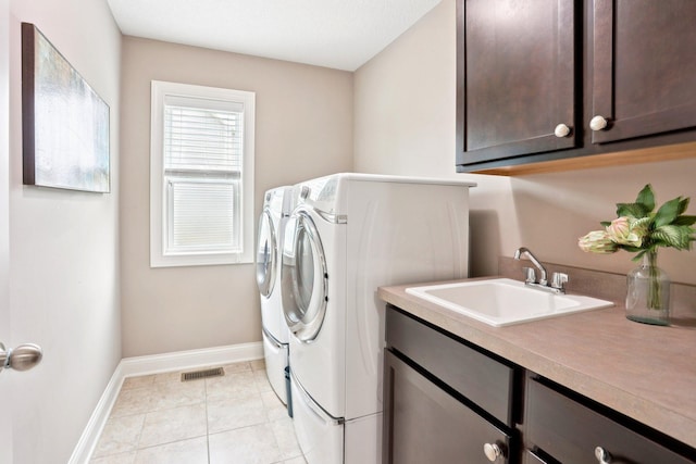 18482 Aubrie Ct, Eden Prairie, MN 55347 - washroom with cabinet space, independent washer and dryer, and light tile patterned flooring