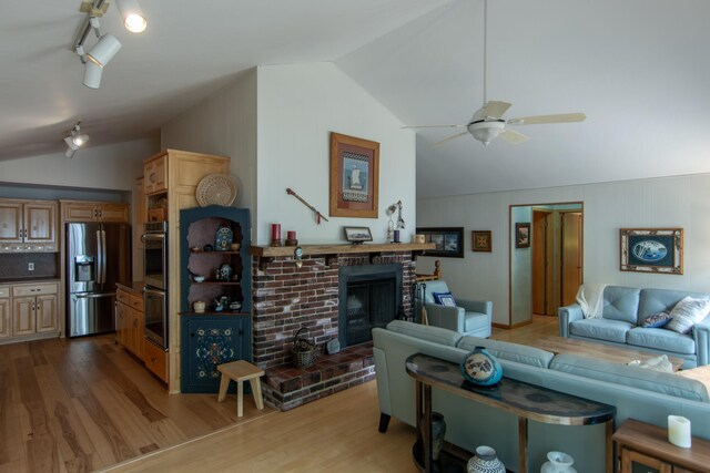 27488 Ridgewood Dr, Merrifield, MN 56465 - living room with lofted ceiling, wood finished floors, a fireplace, and ceiling fan