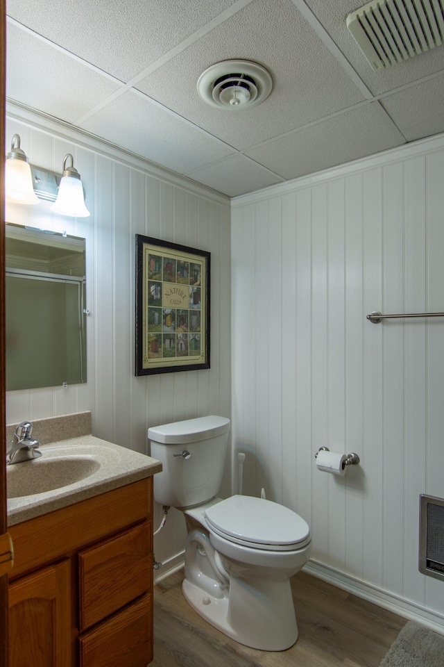 27488 Ridgewood Dr, Merrifield, MN 56465 - full bath featuring wood finished floors, vanity, toilet, a shower, and heating unit