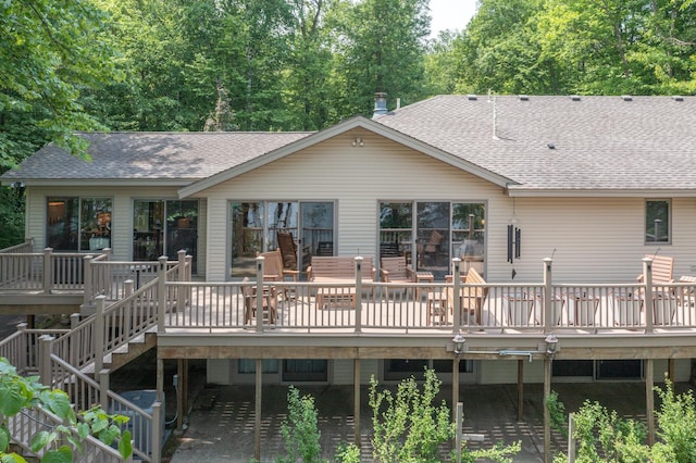 27488 Ridgewood Dr, Merrifield, MN 56465 - back of property with a shingled roof, a wooden deck, and stairs