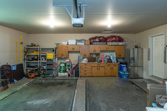 27488 Ridgewood Dr, Merrifield, MN 56465 - garage featuring stainless steel refrigerator with ice dispenser and a garage door opener