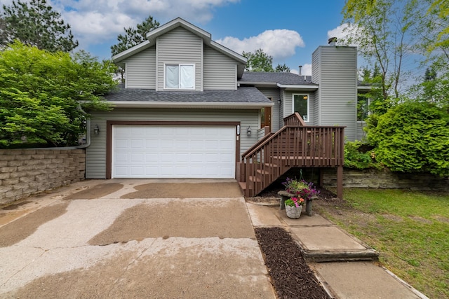 360 117th Ave NW, Coon Rapids, MN 55448 - view of front of property featuring an attached garage, driveway, a shingled roof, and a chimney
