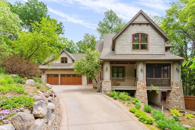 1501 June Ave S, Golden Valley, MN 55416 - craftsman-style house featuring stone siding, roof with shingles, and driveway