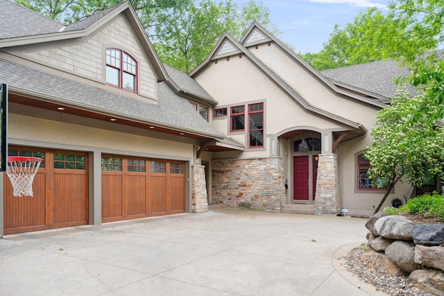 1501 June Ave S, Golden Valley, MN 55416 - view of front facade with roof with shingles, stucco siding, a garage, stone siding, and concrete driveway