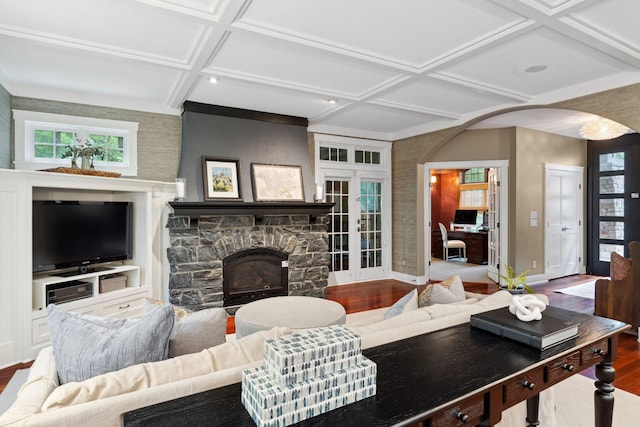 1501 June Ave S, Golden Valley, MN 55416 - living area with coffered ceiling, arched walkways, wood finished floors, a stone fireplace, and beamed ceiling