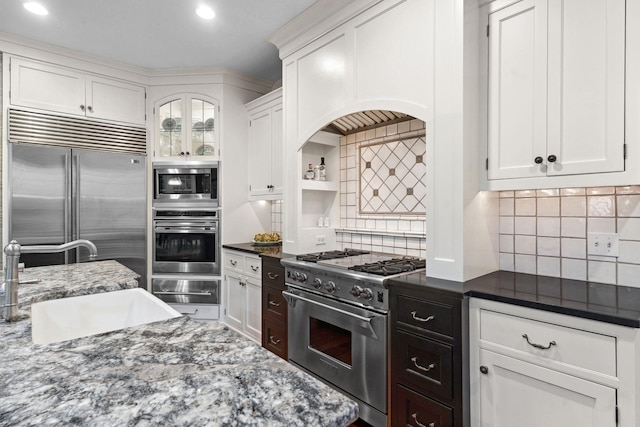 1501 June Ave S, Golden Valley, MN 55416 - kitchen with built in appliances, white cabinetry, a warming drawer, decorative backsplash, and recessed lighting