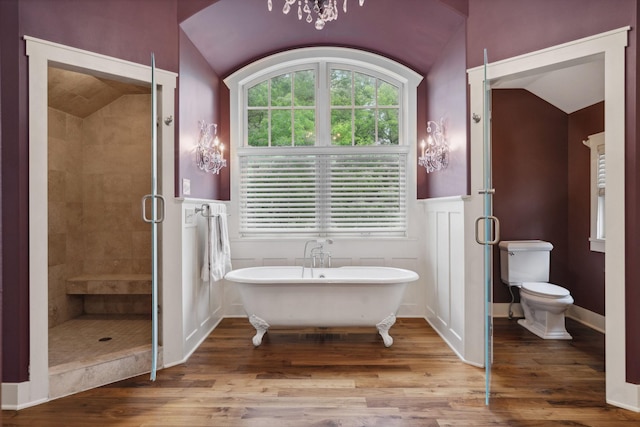 1501 June Ave S, Golden Valley, MN 55416 - bathroom with vaulted ceiling, a shower stall, a soaking tub, wood finished floors, and a wainscoted wall