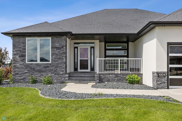 3004 6th St E, West Fargo, ND 58078 - view of front of home with stone siding, a shingled roof, a front yard, and stucco siding