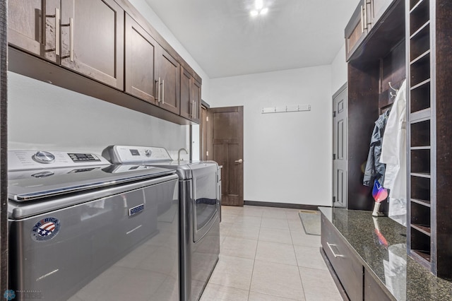 3004 6th St E, West Fargo, ND 58078 - washroom with separate washer and dryer, cabinet space, and light tile patterned flooring