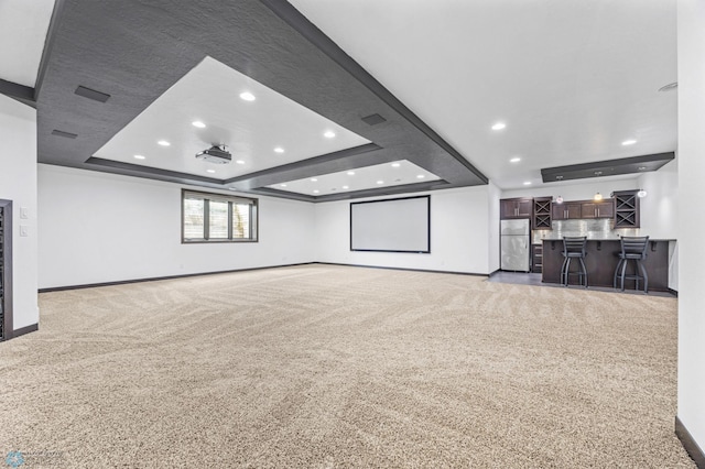3004 6th St E, West Fargo, ND 58078 - cinema room featuring a raised ceiling, light colored carpet, recessed lighting, and baseboards