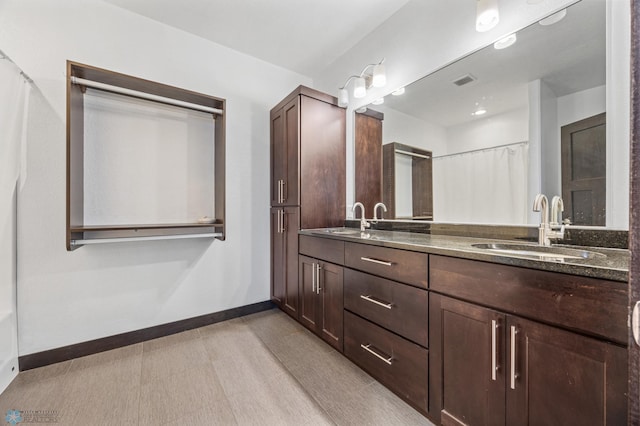 3004 6th St E, West Fargo, ND 58078 - full bathroom with double vanity, baseboards, and curtained shower