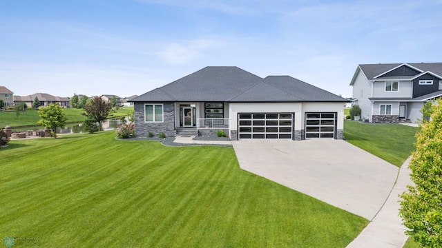 3004 6th St E, West Fargo, ND 58078 - view of front of house with stone siding, an attached garage, driveway, a front lawn, and a water view