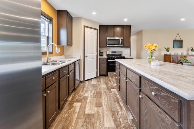 16536 Hook Cir, Pokegama Twp, MN 55030 - kitchen featuring appliances with stainless steel finishes, light wood-type flooring, dark brown cabinetry, light countertops, and recessed lighting