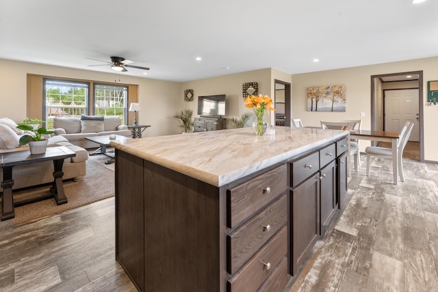 16536 Hook Cir, Pokegama Twp, MN 55030 - kitchen featuring ceiling fan, recessed lighting, a kitchen island, dark brown cabinetry, and open floor plan