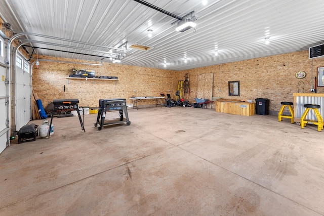 16536 Hook Cir, Pokegama Twp, MN 55030 - garage with a garage door opener and a workshop area
