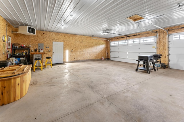 16536 Hook Cir, Pokegama Twp, MN 55030 - garage featuring electric panel, a workshop area, a garage door opener, and a heating unit