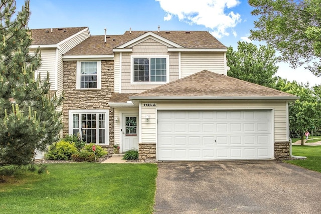 1146 100th Dr NE Unit A, Blaine, MN 55434 - view of front of house featuring stone siding, driveway, roof with shingles, and a front lawn