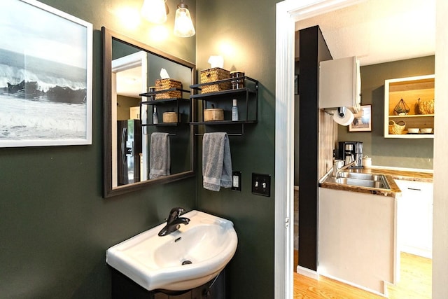1146 100th Dr NE Unit A, Blaine, MN 55434 - bathroom featuring a sink and wood finished floors