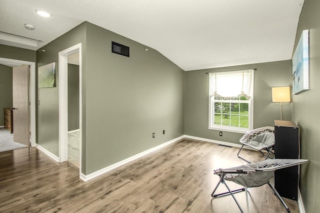1146 100th Dr NE Unit A, Blaine, MN 55434 - unfurnished room featuring wood finished floors, lofted ceiling, and recessed lighting