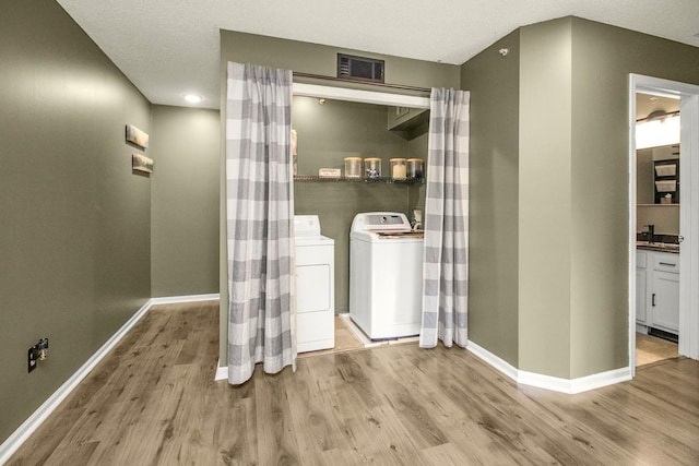 1146 100th Dr NE Unit A, Blaine, MN 55434 - washroom featuring separate washer and dryer and wood finished floors