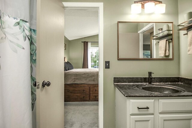 1146 100th Dr NE Unit A, Blaine, MN 55434 - full bathroom with ensuite bathroom, vaulted ceiling, and vanity