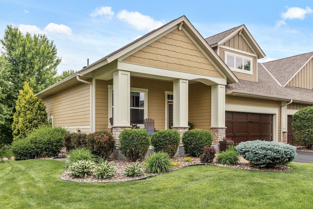 16815 Asterbilt Ln, Lakeville, MN 55044 - craftsman inspired home featuring a front lawn, roof with shingles, board and batten siding, and stone siding