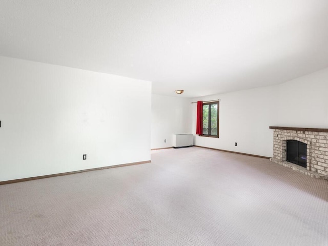 2200 Nevada Ave S Unit 206, Saint Louis Park, MN 55426 - unfurnished living room featuring carpet flooring, a fireplace, and baseboards