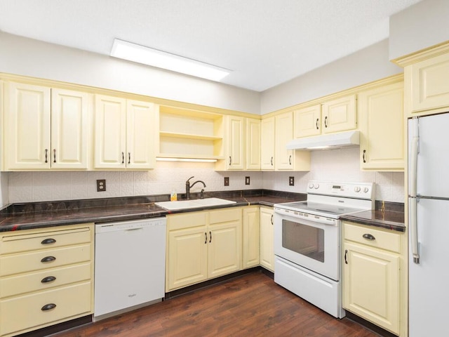 2200 Nevada Ave S Unit 206, Saint Louis Park, MN 55426 - kitchen with white appliances, cream cabinets, a sink, under cabinet range hood, and dark countertops
