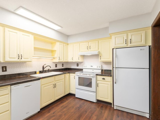 2200 Nevada Ave S Unit 206, Saint Louis Park, MN 55426 - kitchen featuring white appliances, cream cabinetry, a sink, under cabinet range hood, and dark countertops